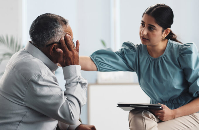 Behavioral Health therapist offering male patient comfort