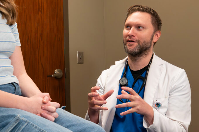 Brett Wergin, MD, talking with patient