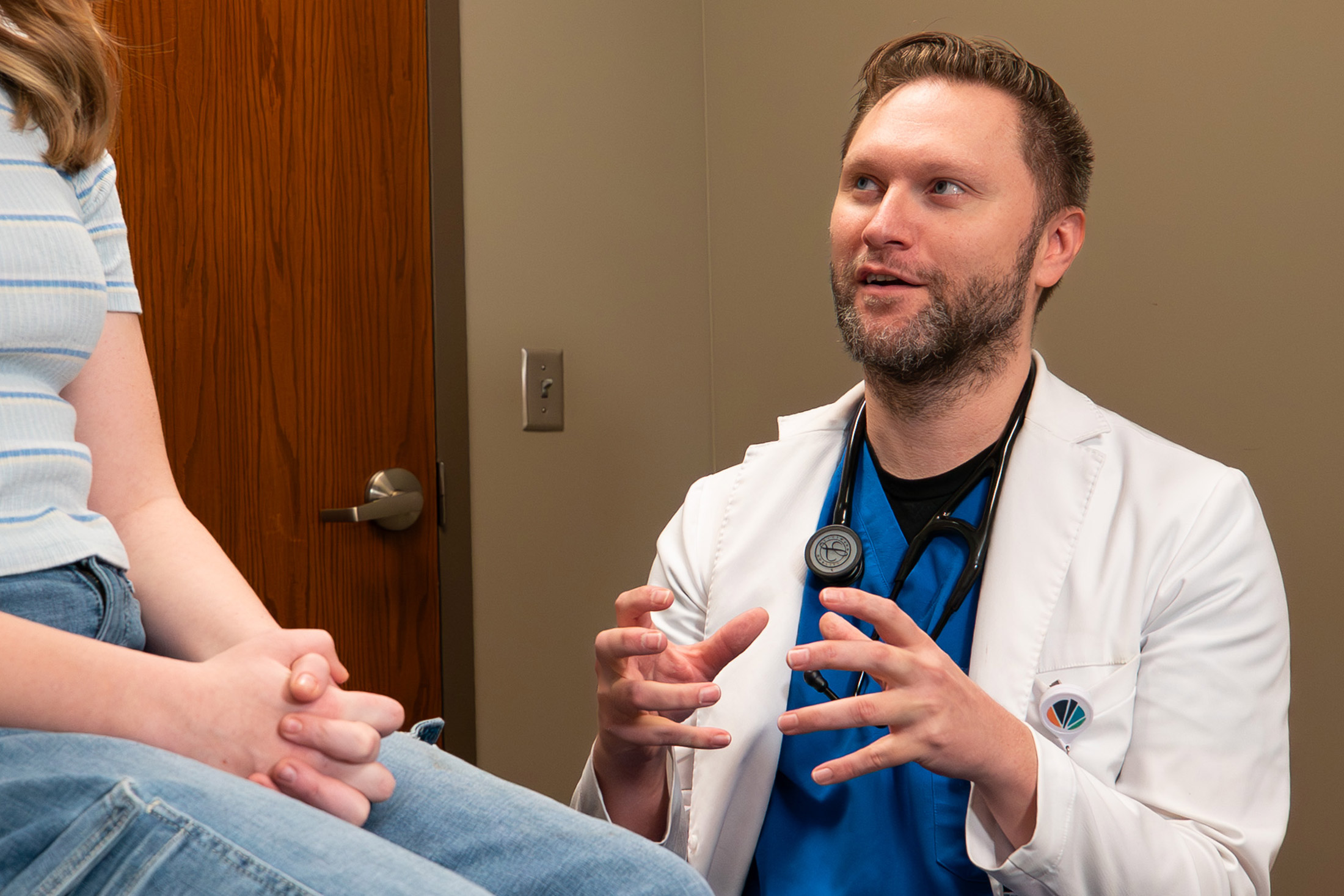 Brett Wergin, MD, talking with patient
